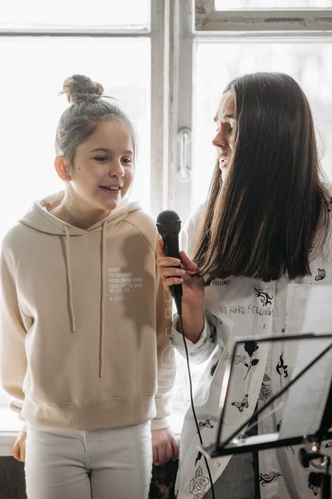 A Woman and Girl Singing Together 